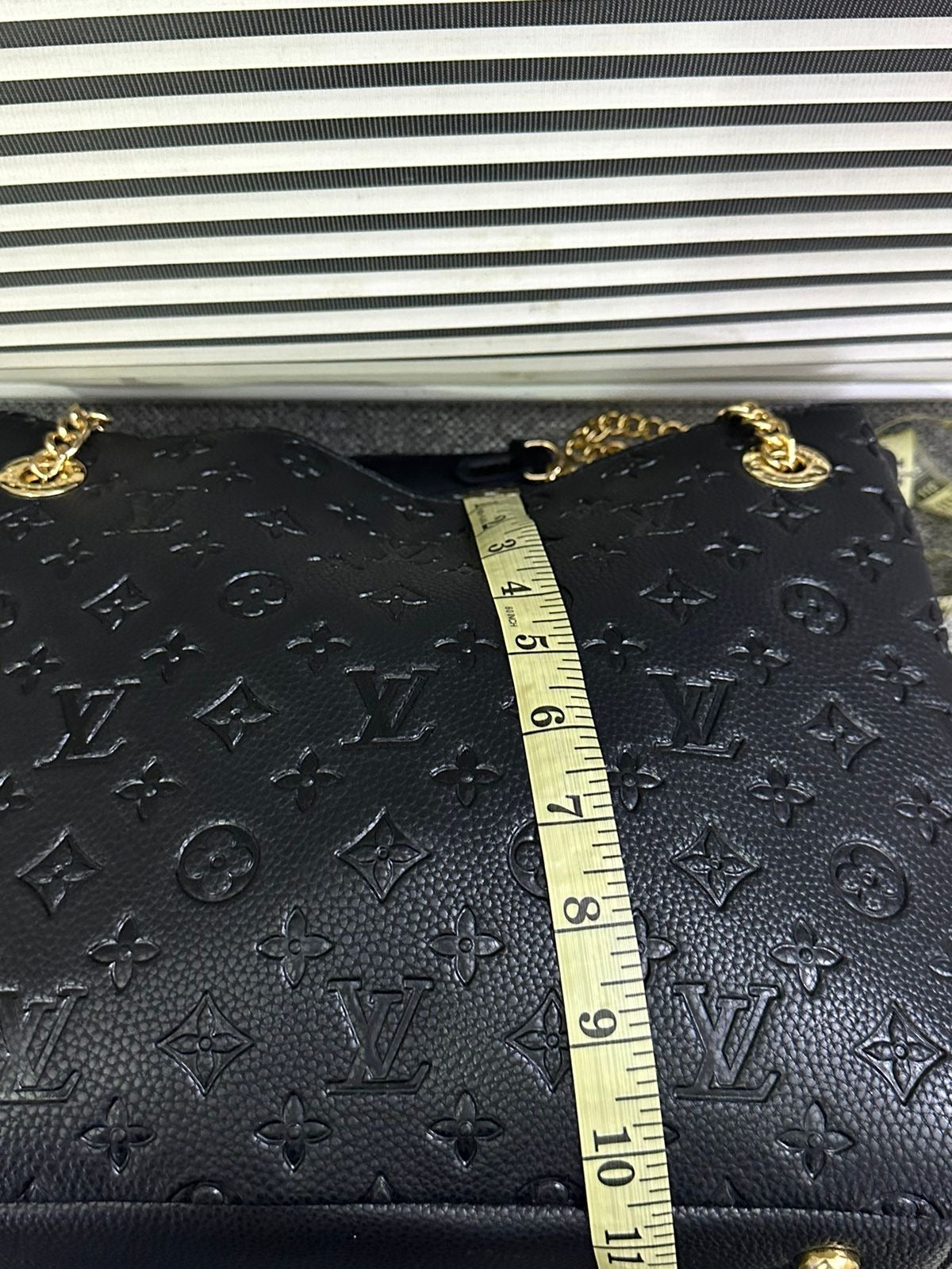 LOUIS VUITTON
Surene MM Monogram Empreinte Leather